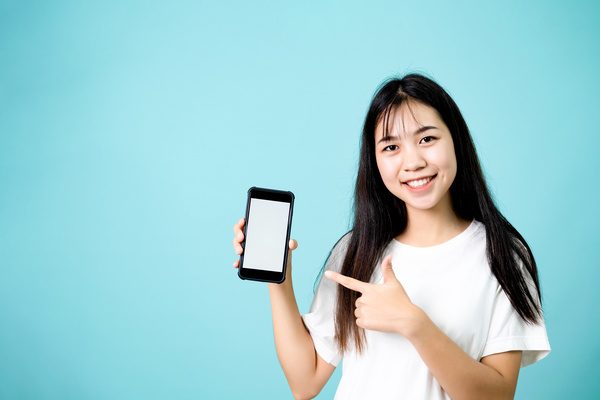スマホを指し示す若い女性